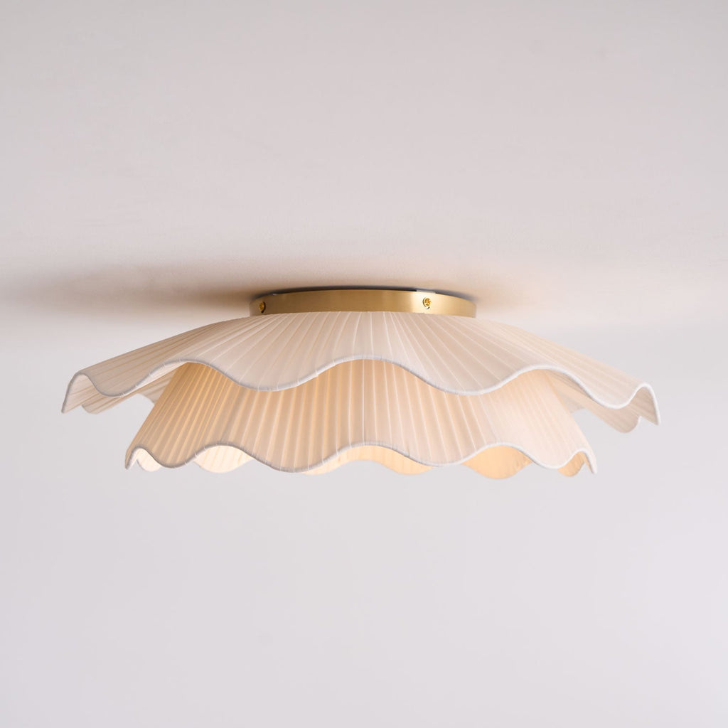 Pleated wave fabric ceiling light mounted in a room setting