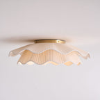 Pleated wave fabric ceiling light mounted in a room setting