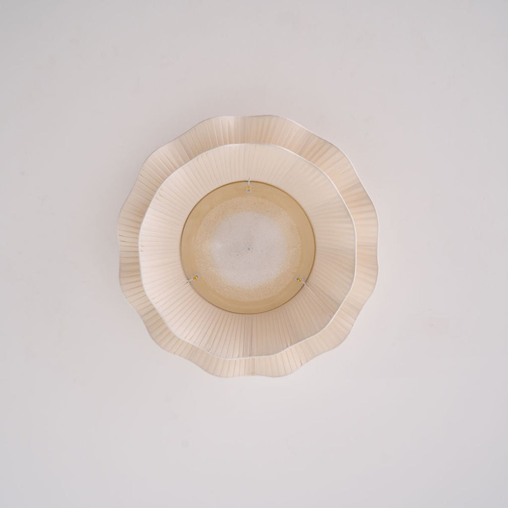 Pleated wave fabric ceiling light with beige shade in a room
