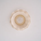 Pleated wave fabric ceiling light with beige shade in a room