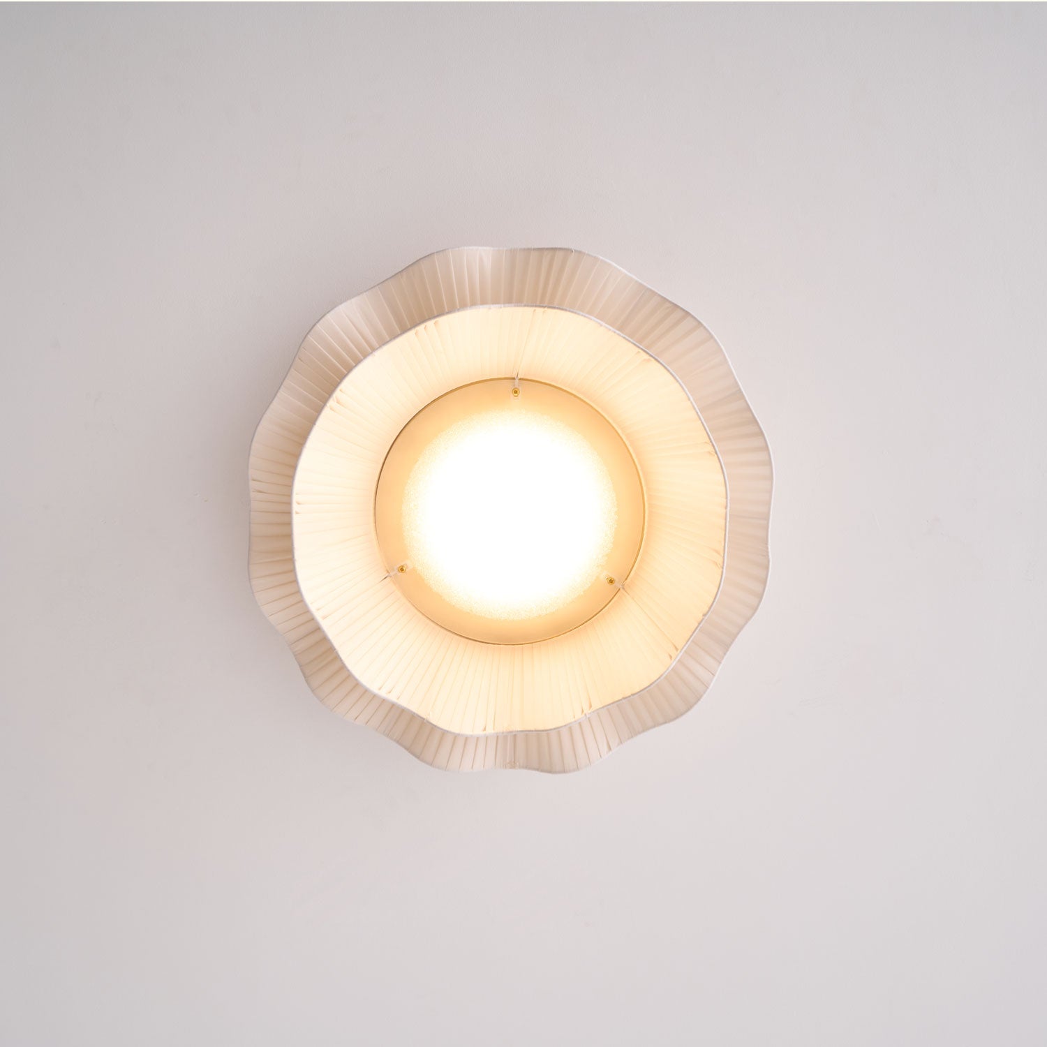 Pleated wave fabric ceiling light installed on a ceiling