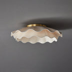 Pleated wave fabric ceiling light shown from below lit