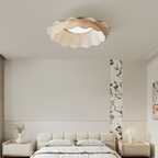 Pleated wave fabric ceiling light glowing in warm light