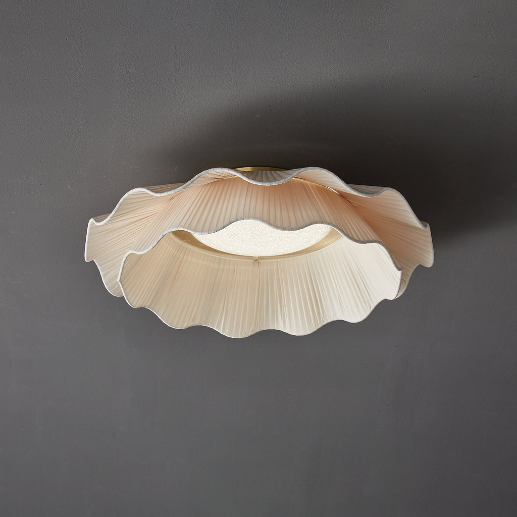 Pleated wave fabric ceiling light close up of brass trim