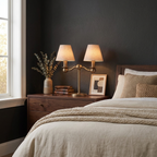 Glowing in brushed brass, this Clérachic table lamp sits on a bedroom dresser beside a vase and framed art.