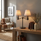 In matte black, this Clérachic table lamp glows on a reclaimed-wood console beside a leather armchair with a throw.