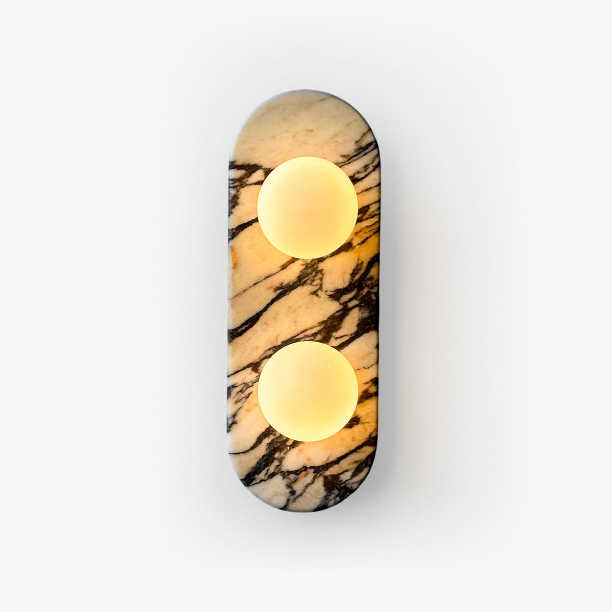 Clérachic marble wall light with two opal glass globes lit warm, shown alone against a plain white background.