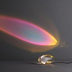 Crystal glass oval table lamp lit softly against a plain wall