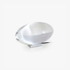 Oval crystal table lamp casting a gentle amber light on a desk