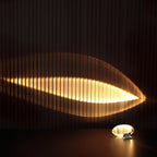 Crystal glass oval table lamp glowing warmly on a chrome base