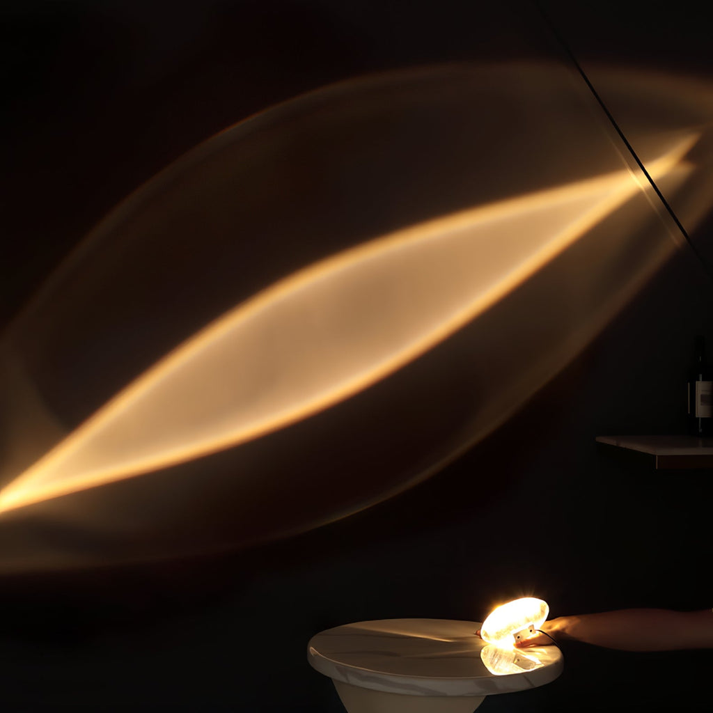 Clear crystal table lamp glowing on chrome base on a desk