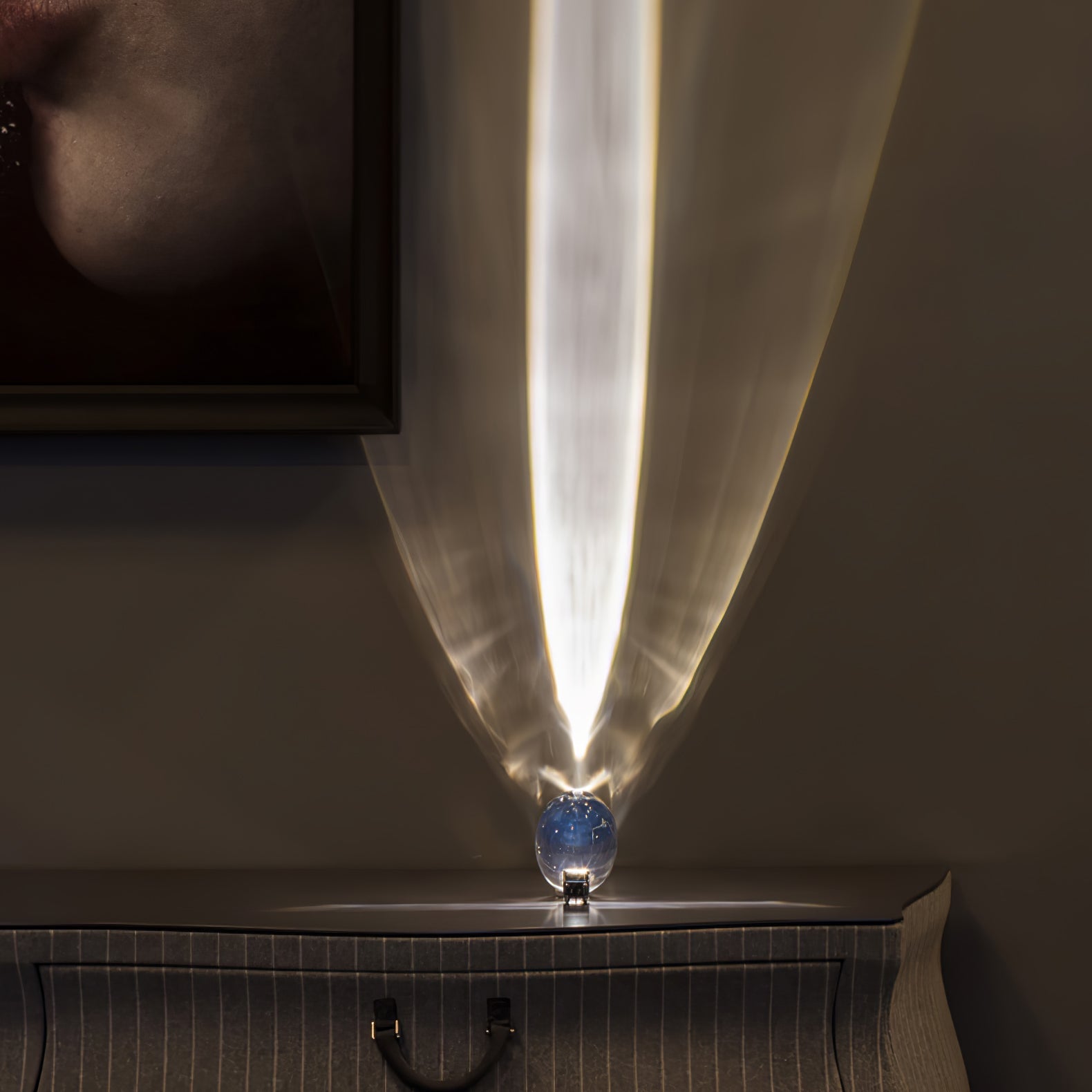 Crystal oval table lamp glowing softly beside a bedside book
