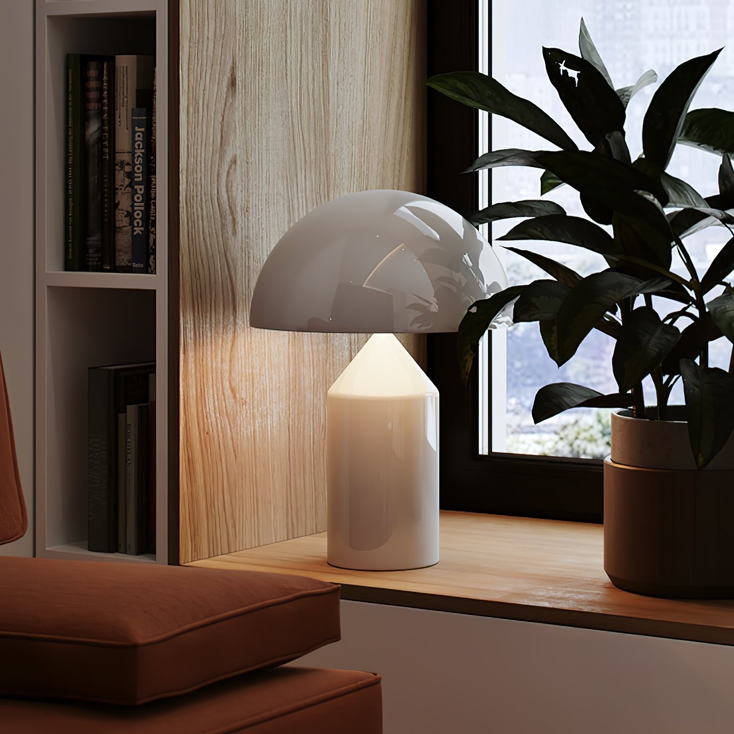 Sculptural metal table lamp lit in a styled interior