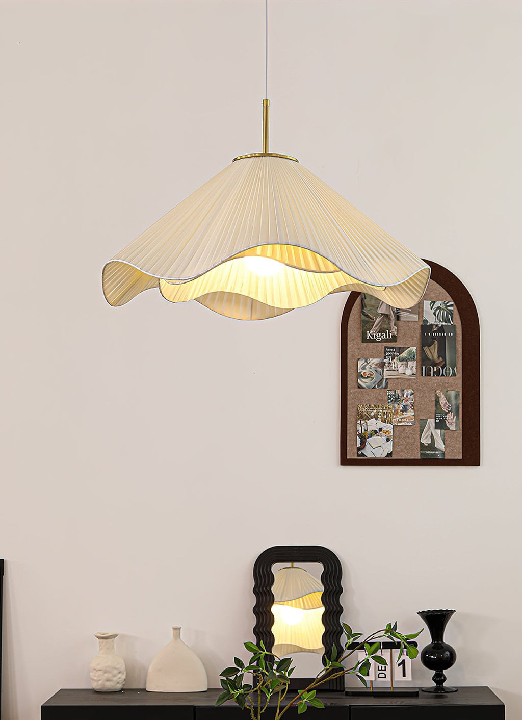 Above a styled console set with a mirror and ceramic vases, this beige Clérachic pendant light glows softly.