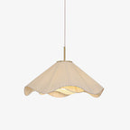 Studio view of this beige Clérachic pendant light, its pleated fabric shade and gold stem shown against a plain backdrop.
