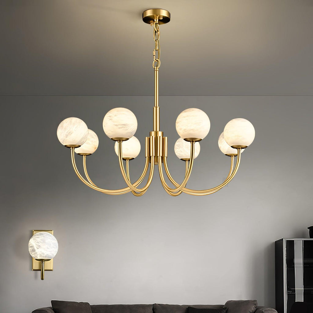 Clérachic lit against a grey wall beside a matching alabaster wall sconce mounted lower left