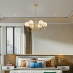 Clérachic hung above a bed with a fluted wood headboard, the alabaster globes reading soft cream in daylight