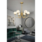 Clérachic hung in a living room with a deep green velvet sofa, round black mirror and framed print