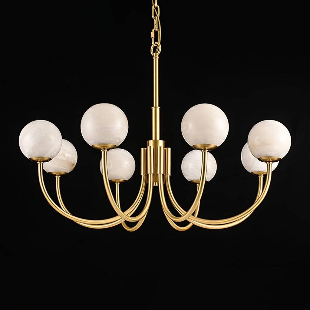 Clérachic lit on a black backdrop with a long chain drop, brass arms curving out beneath the globes