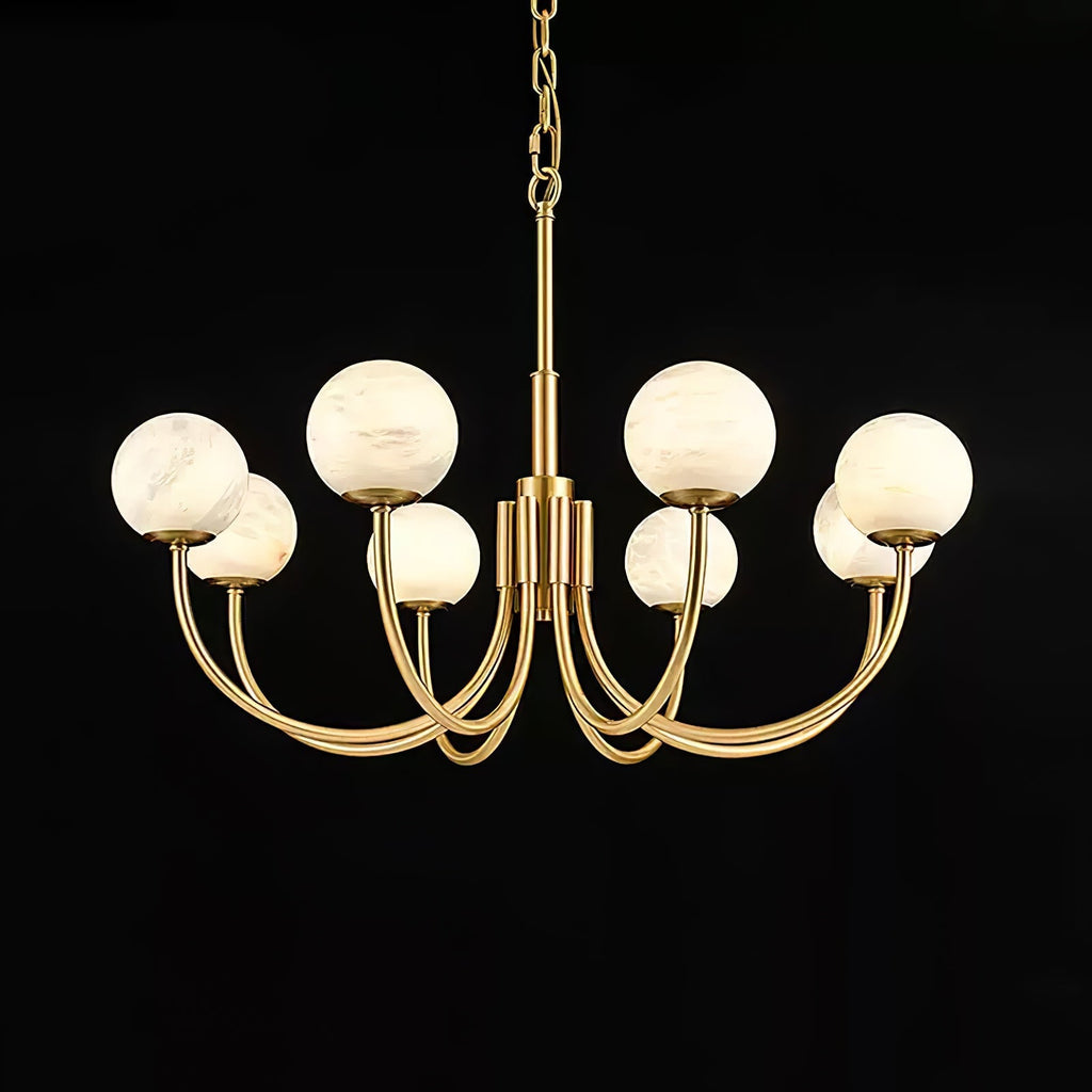 Clérachic lit on black in a wider frame, the warm globes contrasting with the polished brass arms