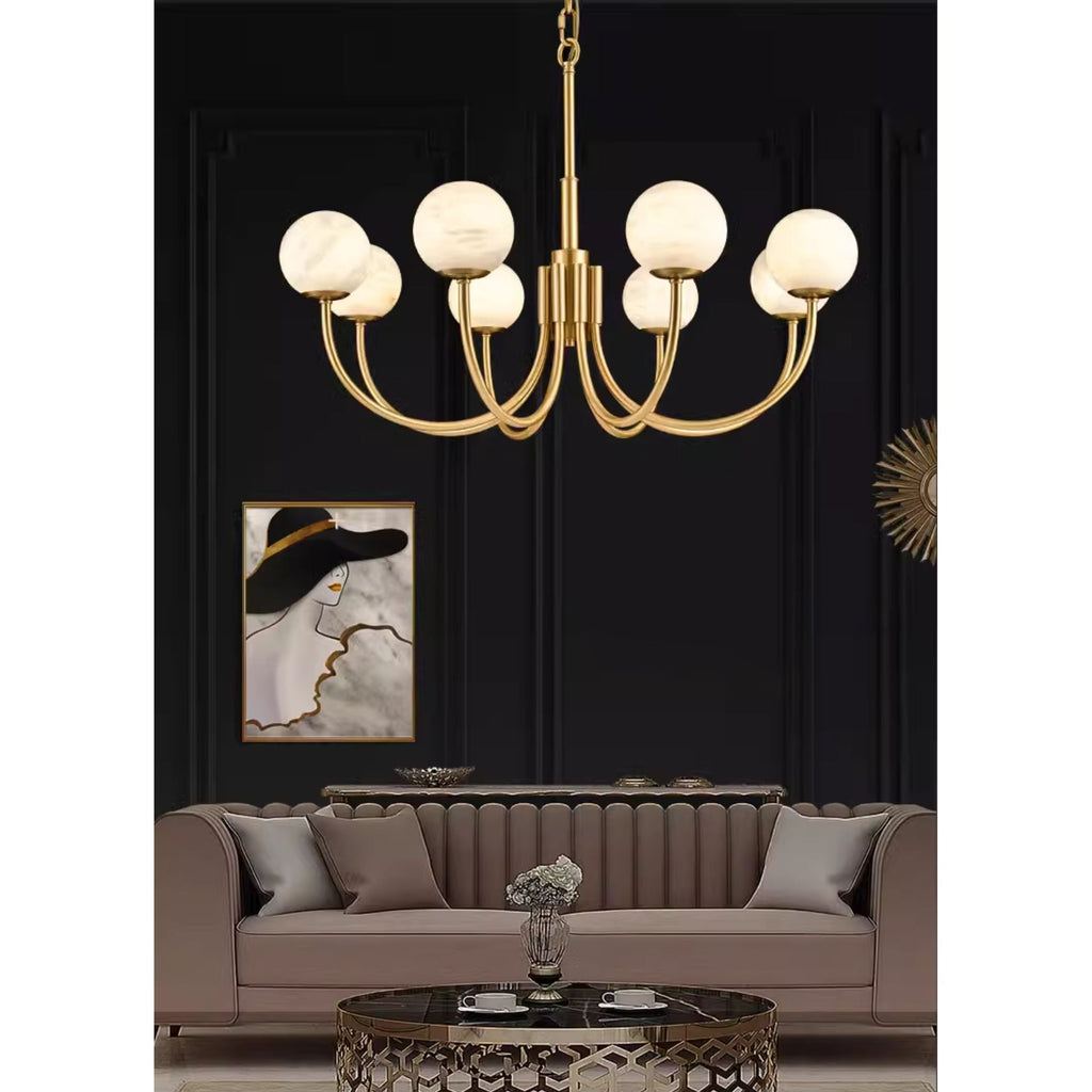 Clérachic lit above a taupe sofa against a black panelled wall with a framed poster alongside