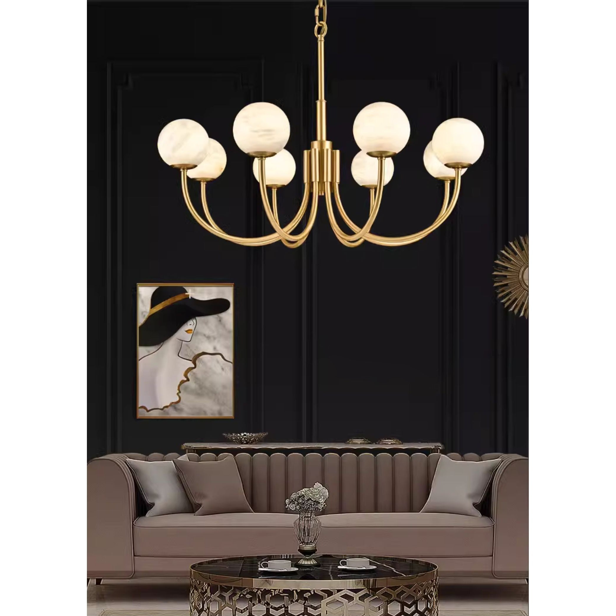 Clérachic lit above a taupe sofa against a black panelled wall with a framed poster alongside