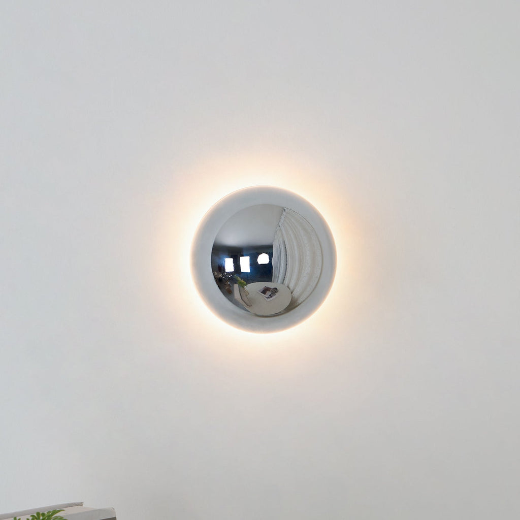 Polished sphere wall sconce close up of gold surface