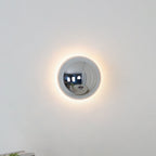 Polished sphere wall sconce close up of gold surface