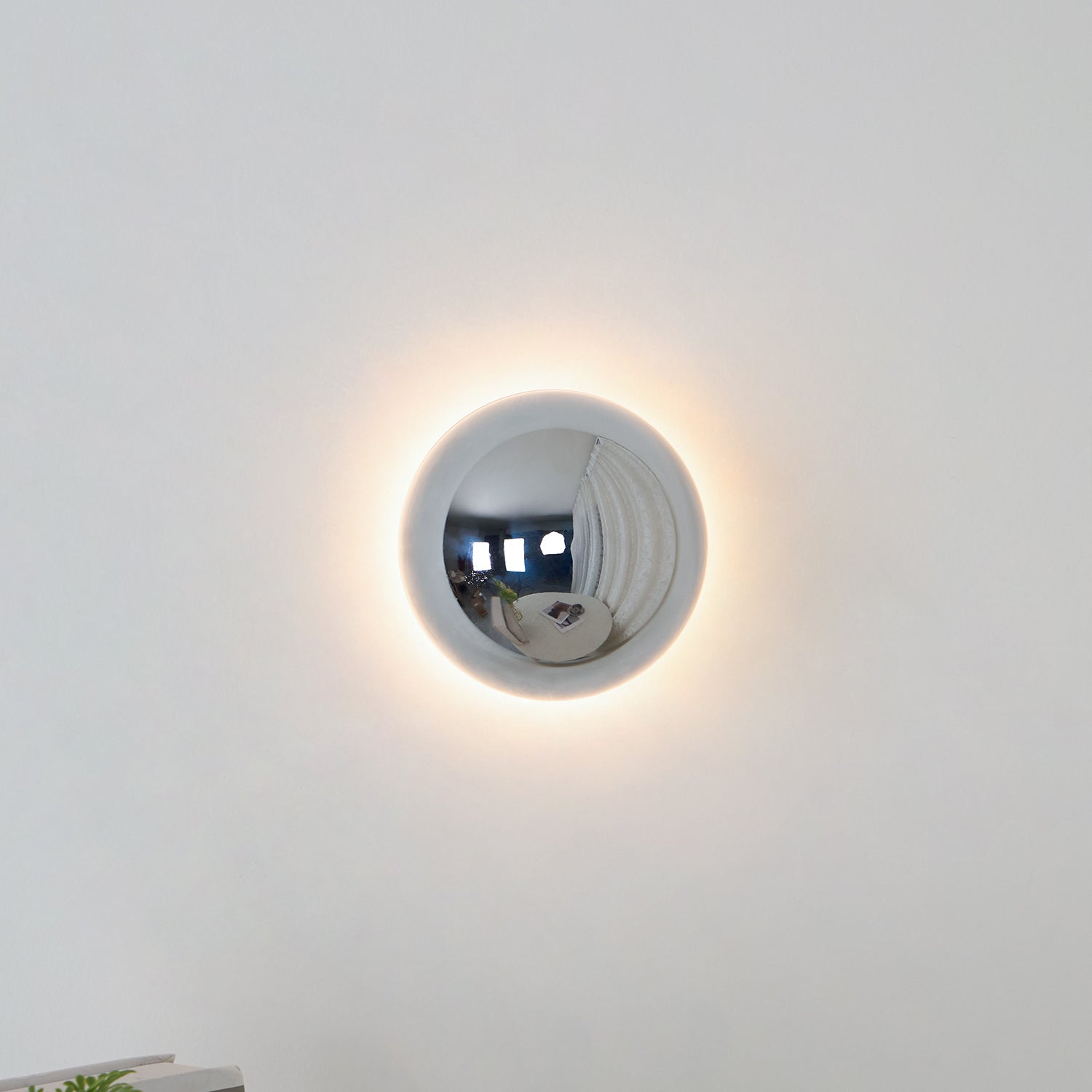 Polished sphere wall sconce close up of gold surface