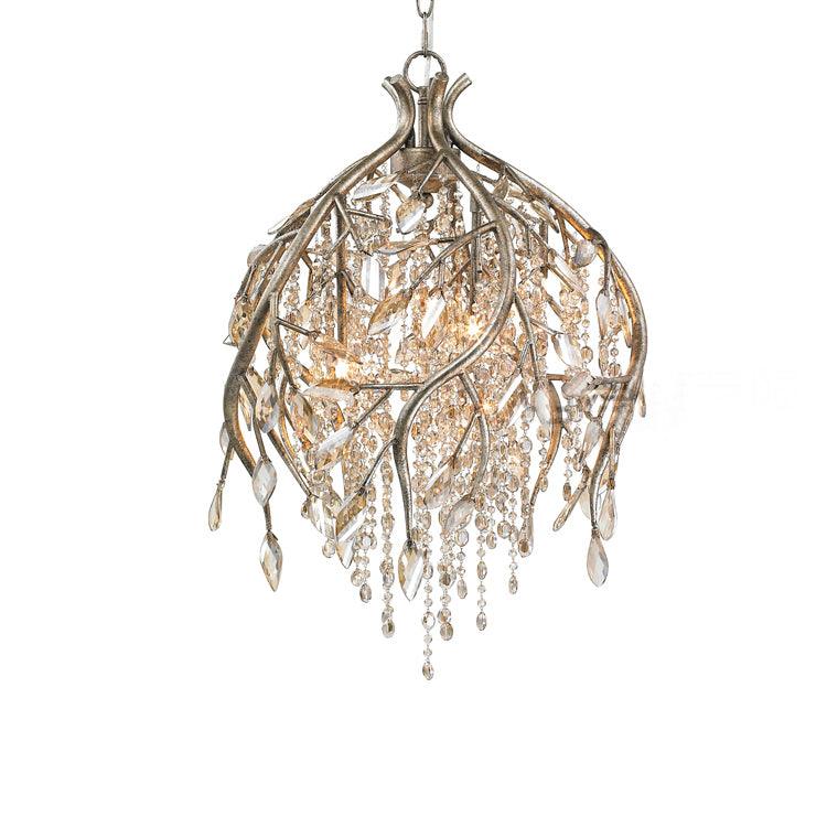 Bell-shaped branch cage in gold, leaf-tipped stems falling around amber bead strands.
