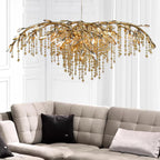 The gold version lit above a beige tufted corner sofa on a white panelled wall.