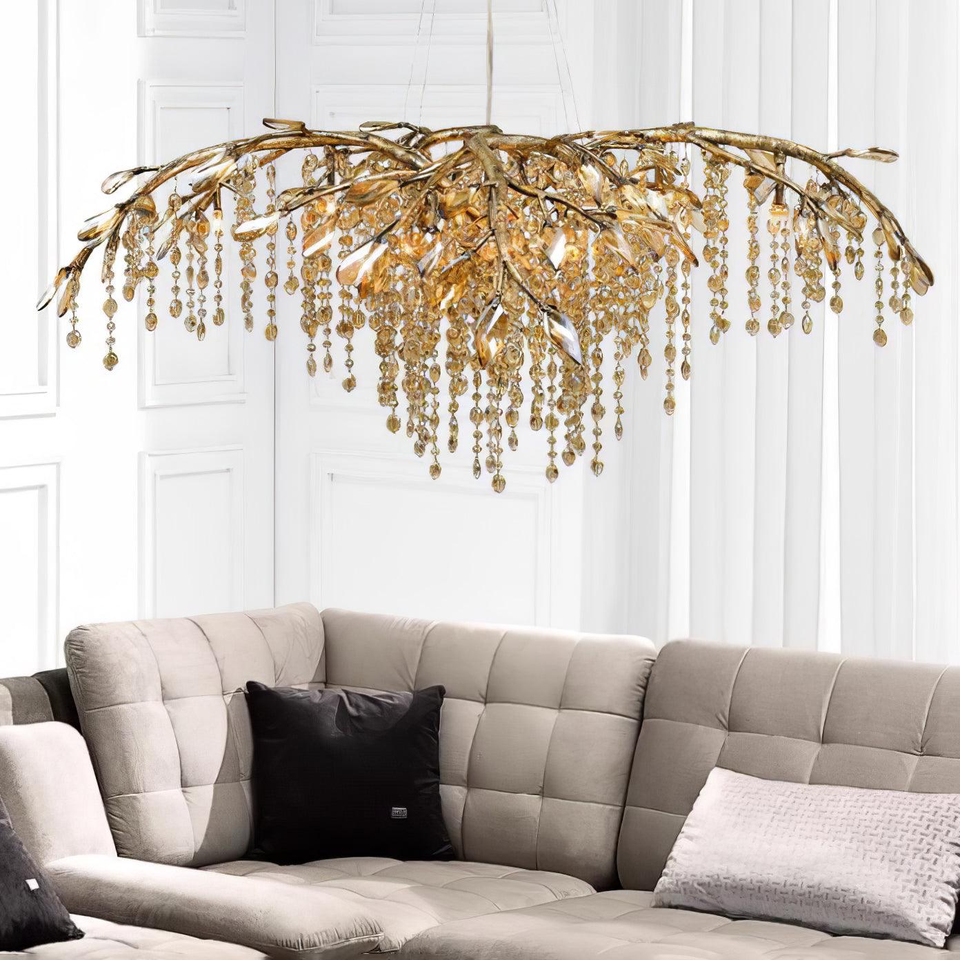 The gold version lit above a beige tufted corner sofa on a white panelled wall.