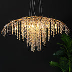 The gold version lit against a black wall, a palm frond entering at the right.