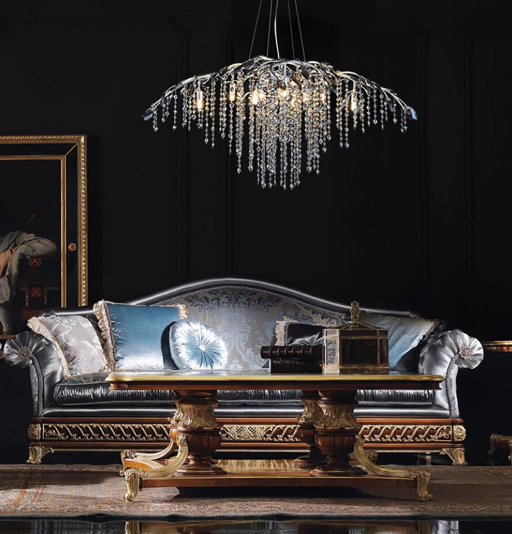The silver version lit above an ornate blue silk sofa against black panelling.