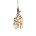 Small branch-cage pendant in gold, amber glass beads hanging inside twisted metal stems, on a chain.