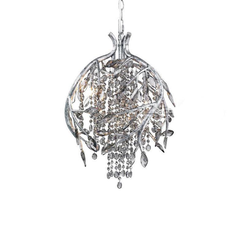 The round cage pendant in silver, its branches wrapping a core of clear grey beads.