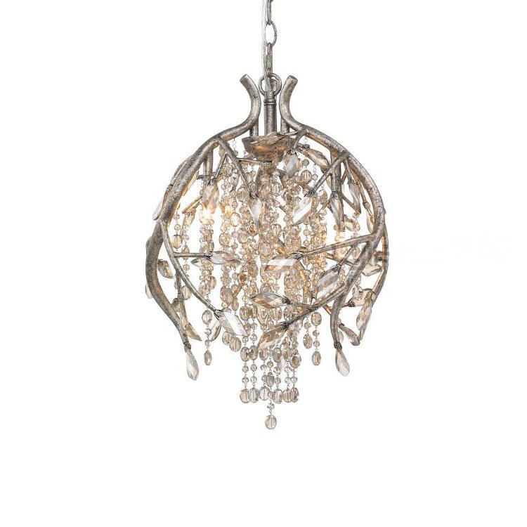 Round cage pendant in gold, branches curving into a globe around amber bead strands.