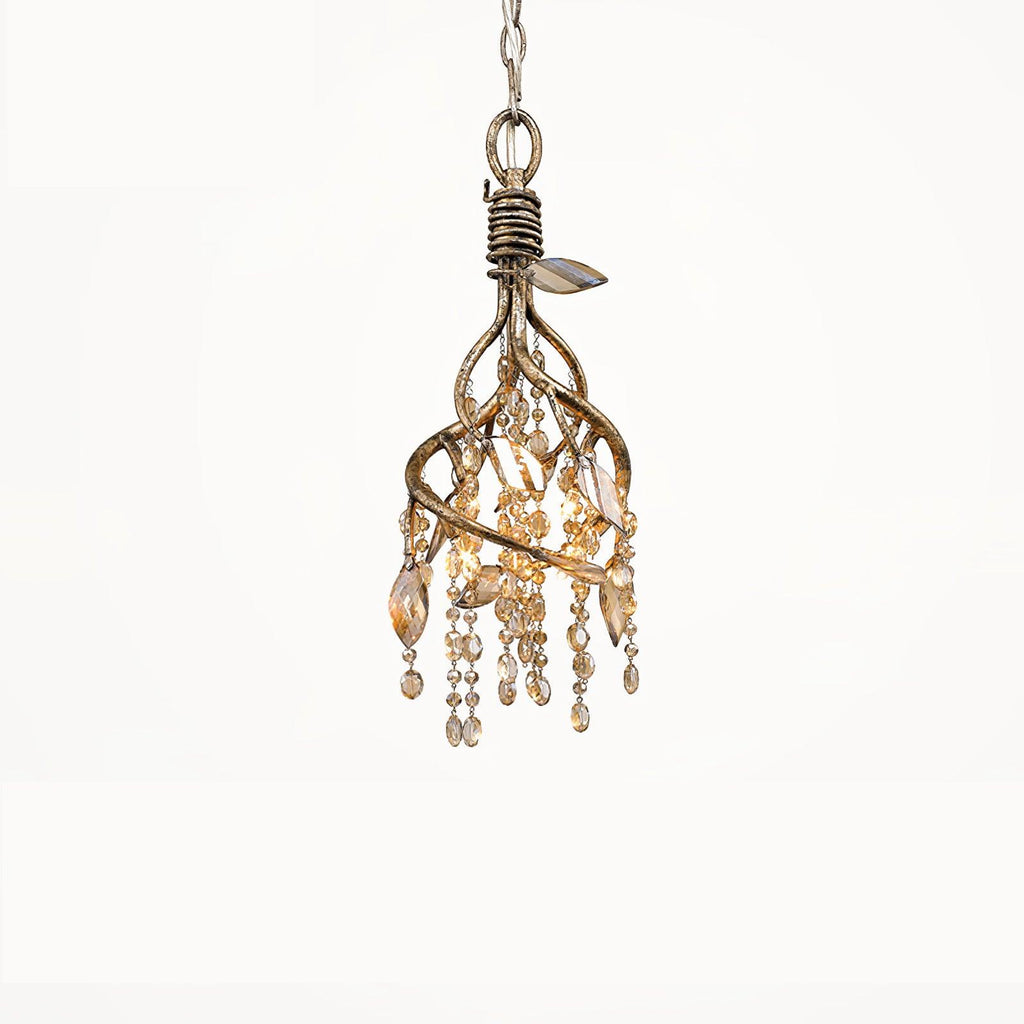 The small gold pendant on white, its beads and leaf crystals gathered under a twisted collar.