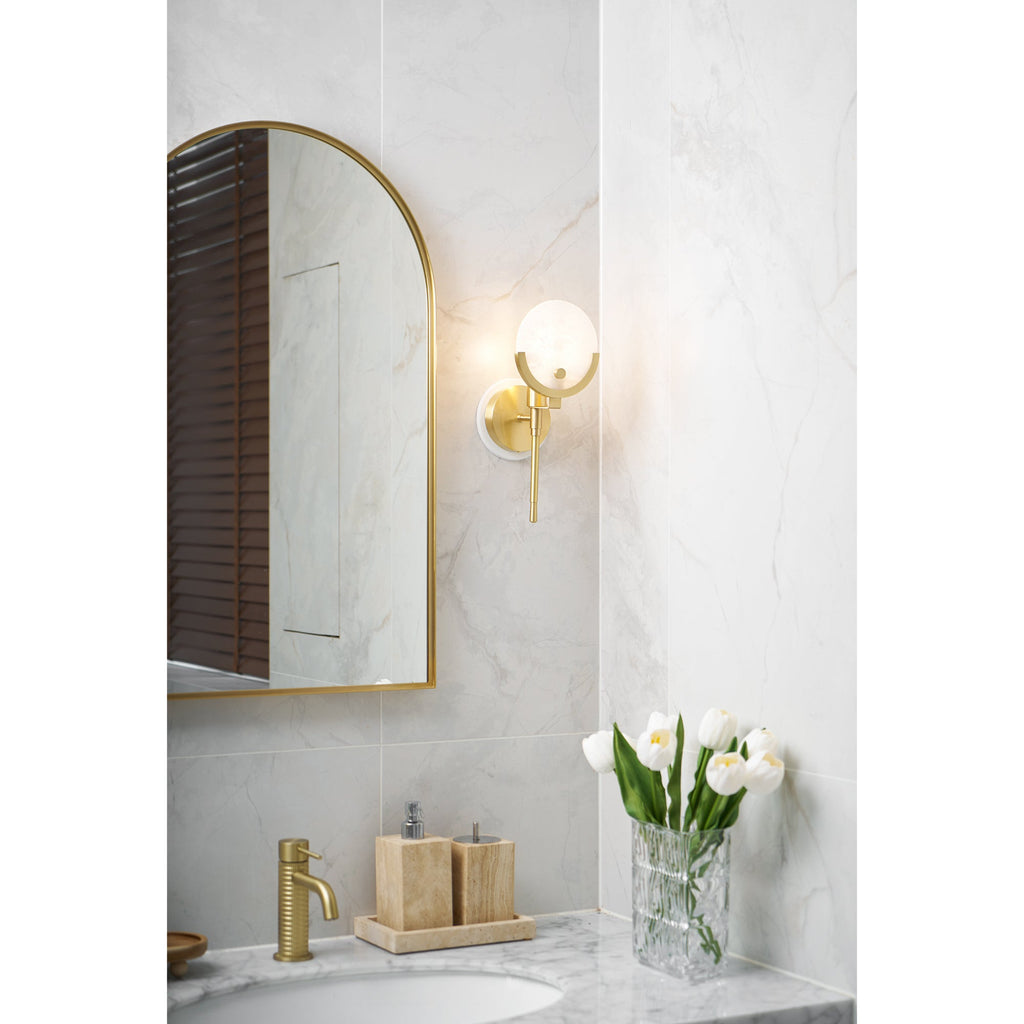 Clérachic zavarara sconce lit above a marble bathroom vanity, beside an arched mirror and white tulips.