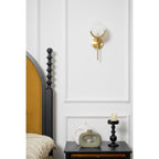 Clérachic compact Zavarara wall light unlit on white panelling, with the bed's dark headboard to one side.