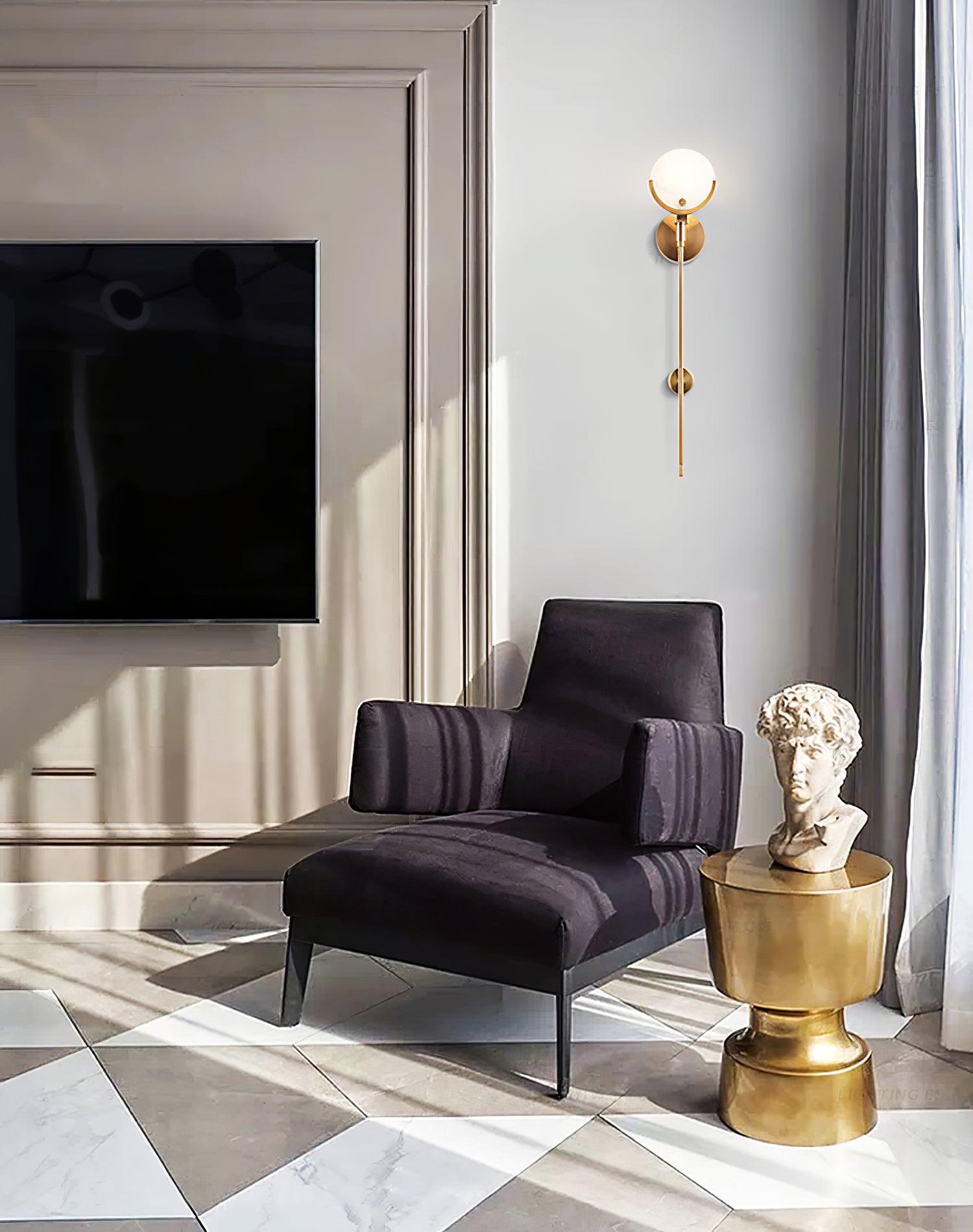 Clérachic zavarara wall light lit in a living room with a chequerboard marble floor and brass plinth table.
