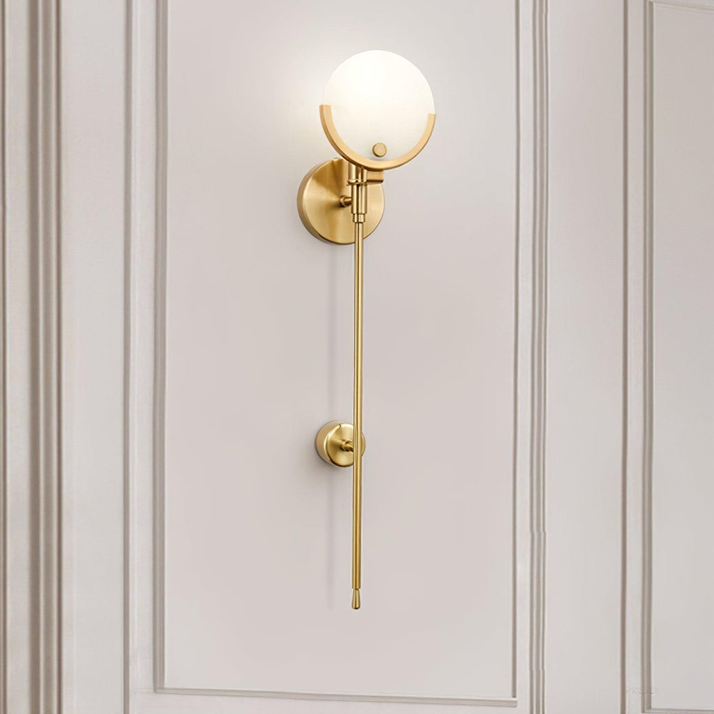 Clérachic tall Zavarara sconce lit on a cream panelled wall, seen at an angle with the opal shade aglow.
