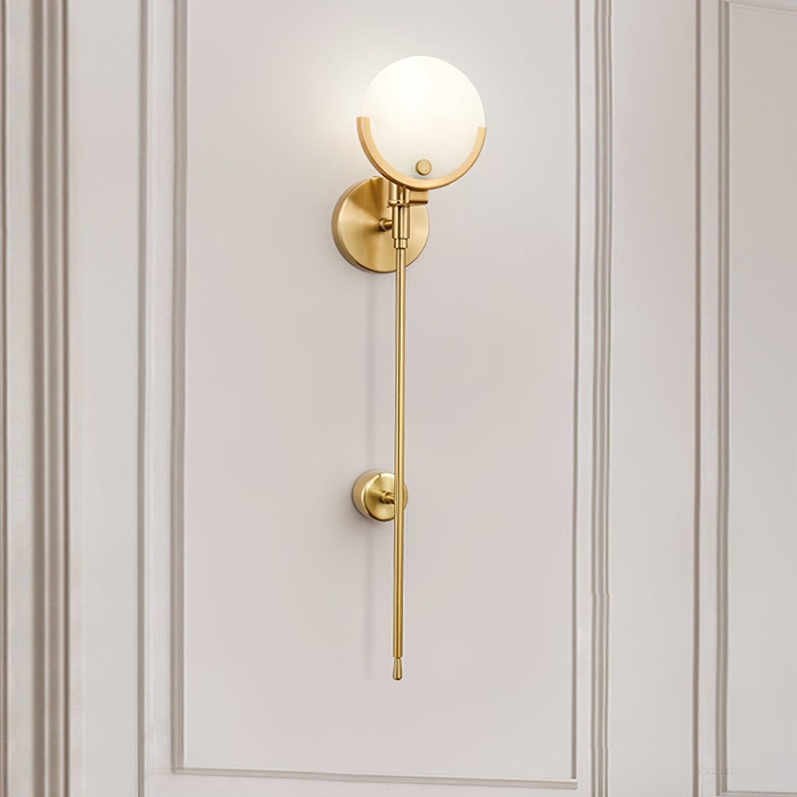 Clérachic tall Zavarara sconce lit on a cream panelled wall, seen at an angle with the opal shade aglow.