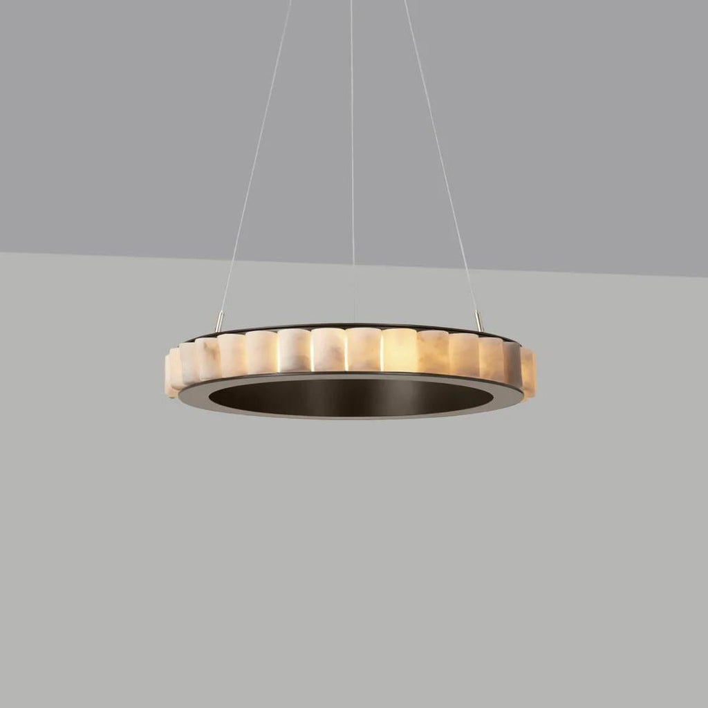 Dark bronze alabaster chandelier lit against a grey backdrop, warm glow inside a dark metal ring.