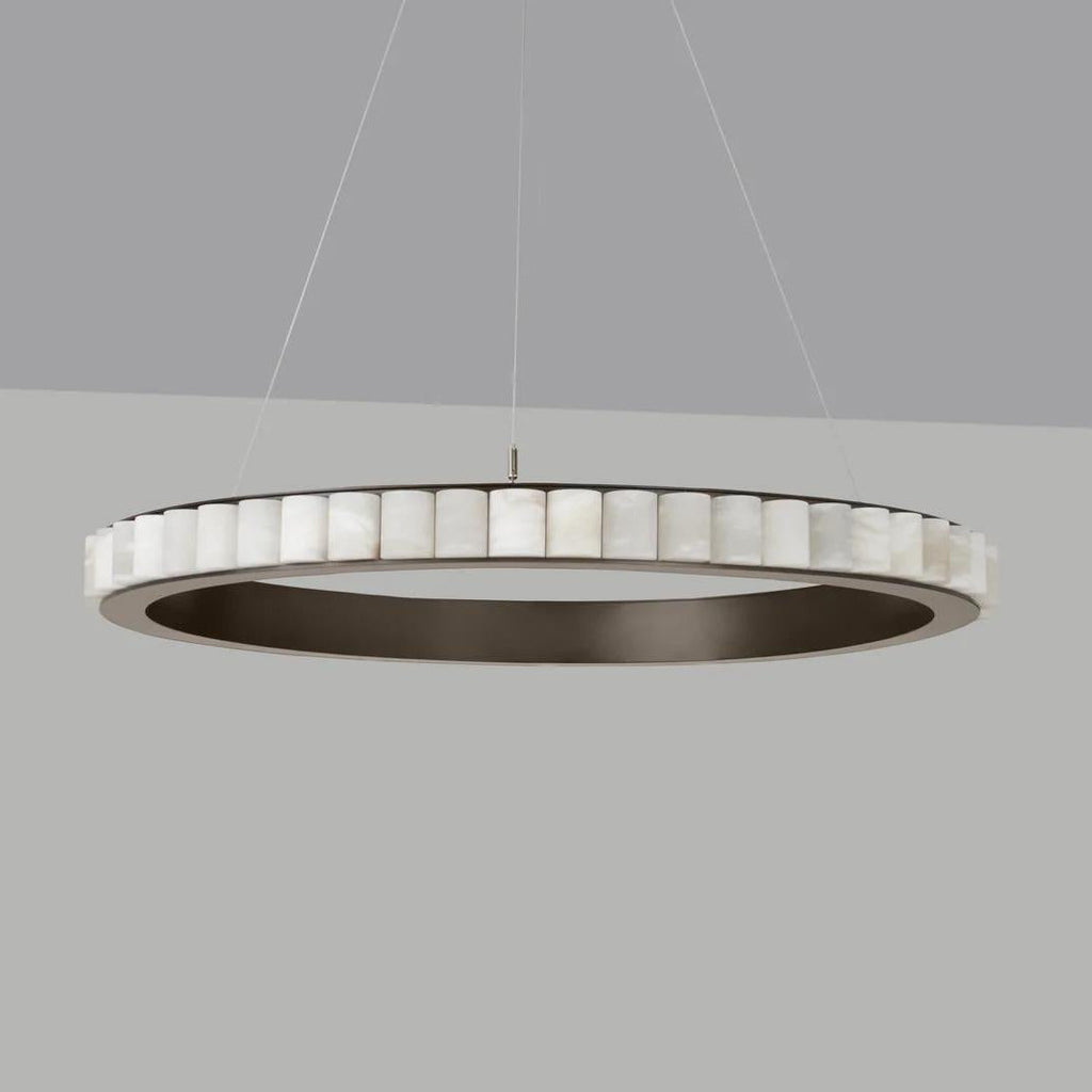 Large dark bronze alabaster chandelier unlit on a grey backdrop, stone tiles ringing the frame.
