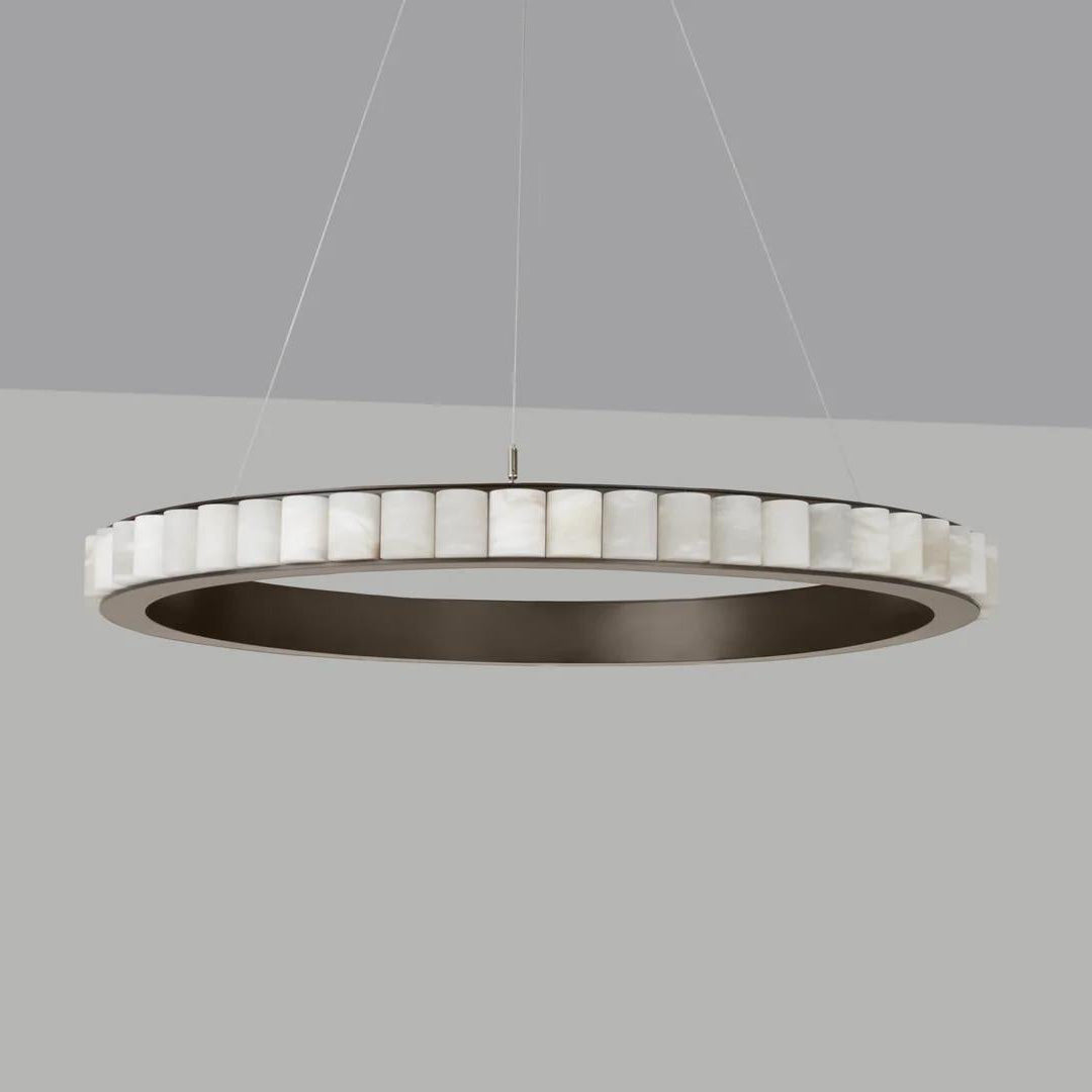 Large dark bronze alabaster chandelier unlit on a grey backdrop, stone tiles ringing the frame.