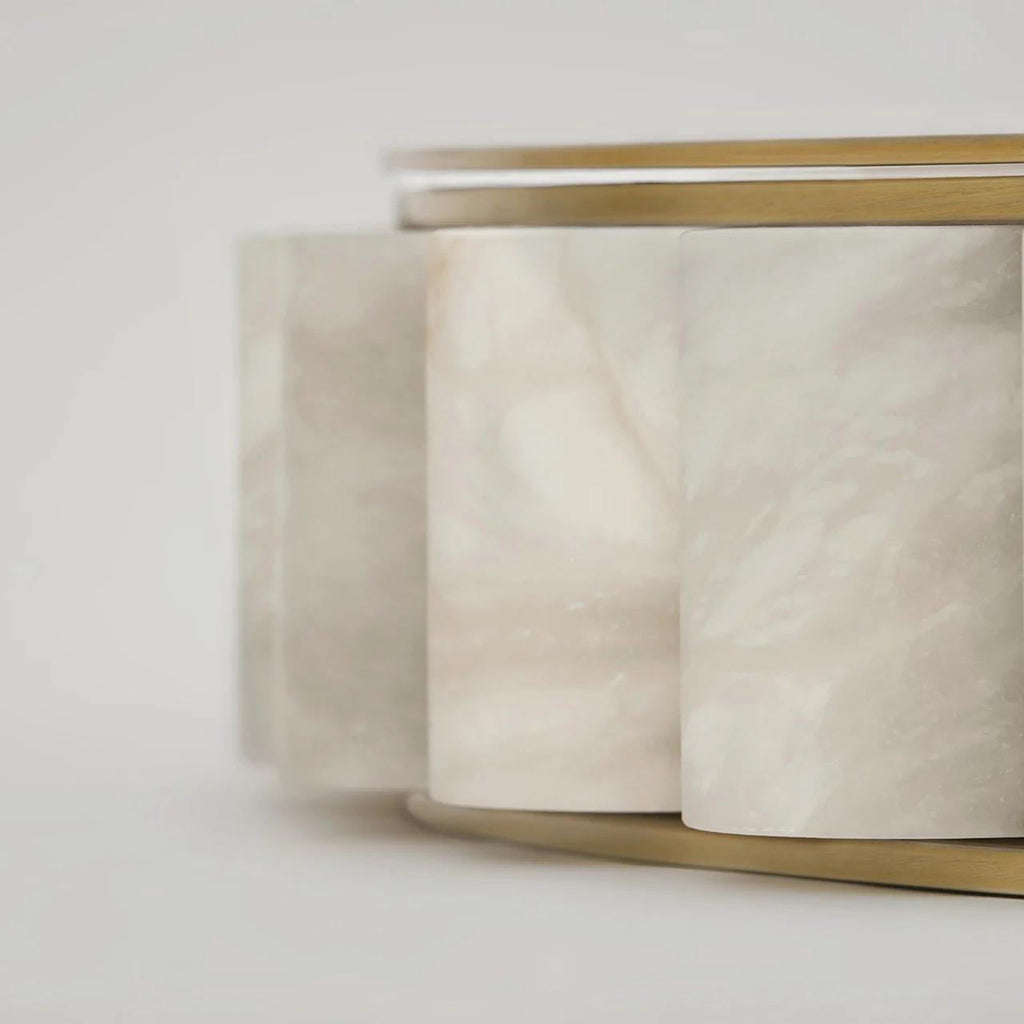 Macro detail of the alabaster tiles, natural cream veining running through each stone cylinder.
