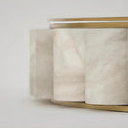 Macro detail of the alabaster tiles, natural cream veining running through each stone cylinder.
