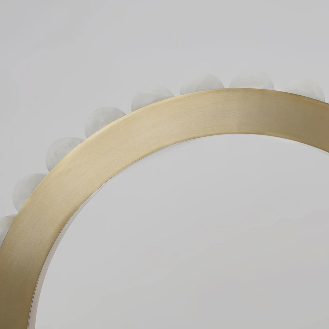 Overhead close-up of the brass ring curving away, alabaster tiles rising behind the metal band.
