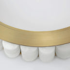 Detail of the brass rim seated on rounded alabaster tiles, showing how the stone is set.